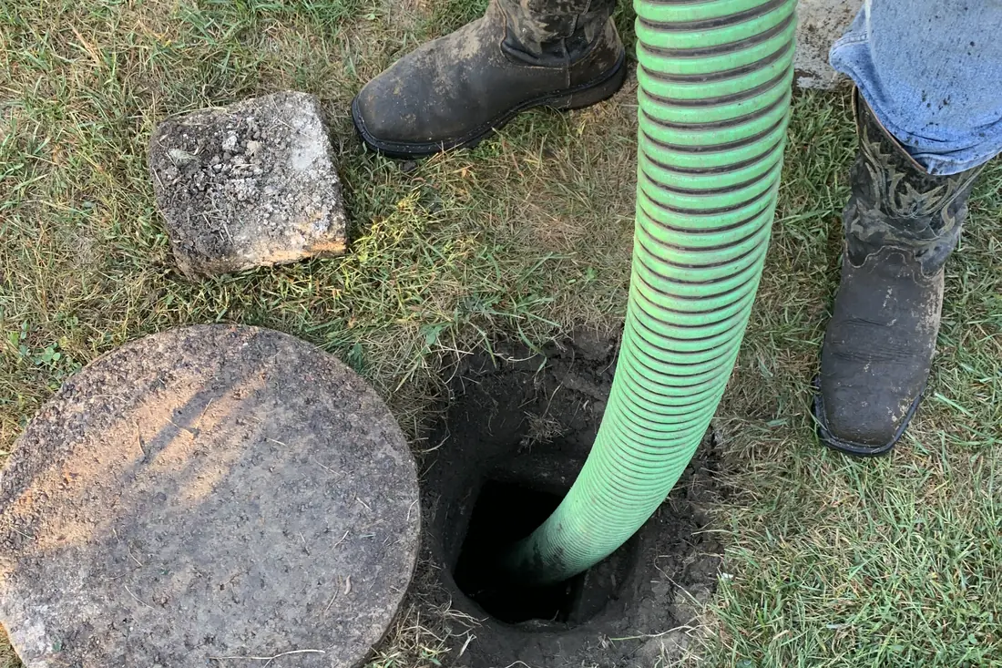 Crew working a specialty access with hose in place